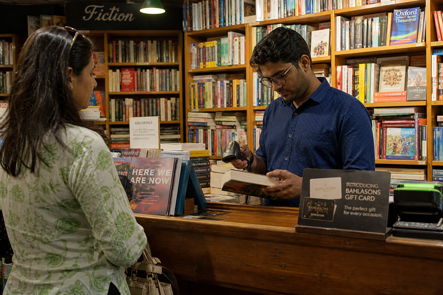 Independent bookshop interior with stacked shelves and a cashier at the counter